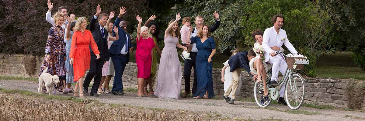 wedding-guests-waving-off-newlyweds-on-bicycles
